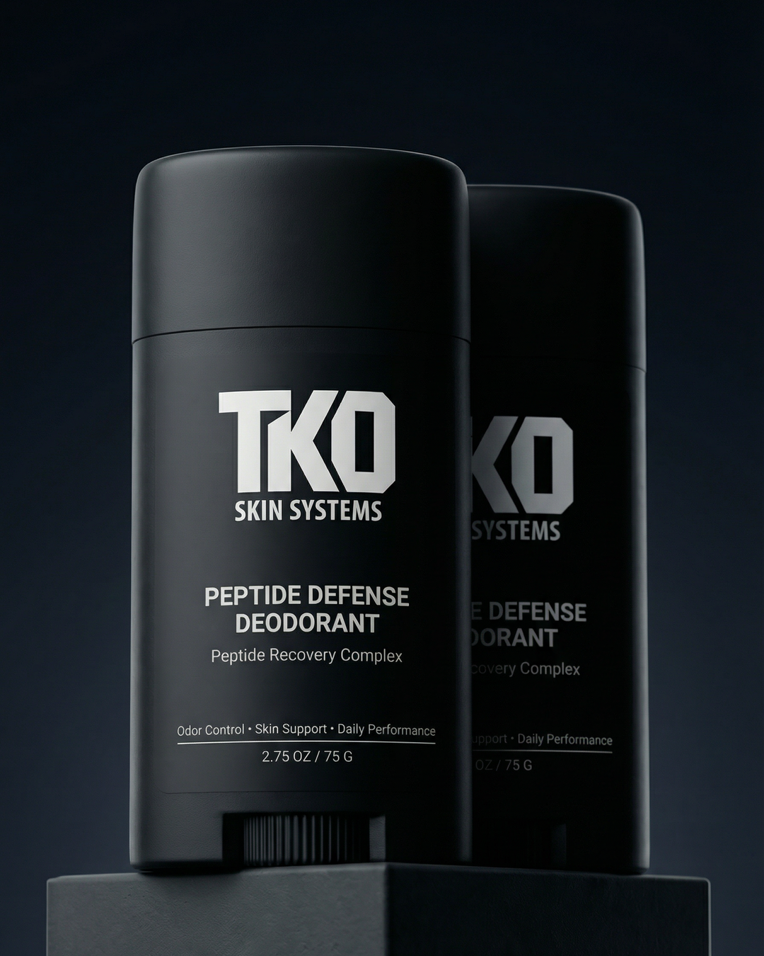 Two black deodorant sticks with 'TKO Skin Systems' branding on a dark background